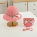 Detailed texture of pink woven straw sun hat and matching crossbody bag with polka dot bow - Hat + Bag Set / Watermelon red