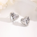 Macro shot of silver heart earrings with lava texture and centered sparkling zircon stone - Hammered Single Heart Zirconia-Silver