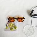 Vintage oval sunglasses featuring a glossy black frame and vibrant orange lenses - Black Orange