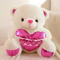 White teddy bear plush toy holding a pink LOVE heart cushion with shiny accents - White / 40CM