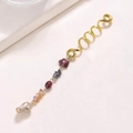 Detailed view of golden snake-shaped hair rings with floral charms and pearls - Coffee Flower Long Style E9322