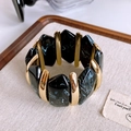 Detail of vintage stretch bracelet with black marble resin and gold metal accents - Gold Black Marble Pattern Resin