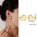 Macro view of heart-shaped pearl stud earrings with textured gold border and size specs - Zjge0495