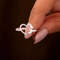 Elegant heart-shaped silver ring with small diamonds shown on a hand in close-up shot - US 6 / White Zirconia