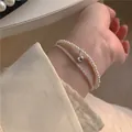 Bracelet double rang avec perles et boule argentée pour femme au design élégant et épuré - Bracelet double argent