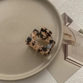 Macro detail of tortoiseshell square cutout hair claw clip on a decorative tray - Light Tortoiseshell