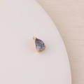 Macro shot of a teardrop-shaped blue zircon charm with gold-plated four-prong setting - Royal Blue (2#)