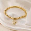 18K gold-plated beaded bracelet featuring a sparkling Hamsa Hand charm on ivory silk - Hamsa Hand Style (32027)