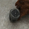 Macro shot of vintage steel compass ring with detailed N S E W engravings on rock - US 7 / Antique Silver