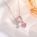Detailed close-up of a silver necklace with pink enamel heart and crystal charms on silk - Silver Pink Heart Style