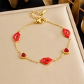 Golden chain bracelet with red lips and heart charms displayed on a stylish stand - Red Lips Heart Red Stone Style (B1779)