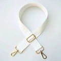 Close-up of adjustable white canvas shoulder strap with gold-tone metal buckles - Gold Buckle / Pure White
