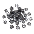 Detailed close-up of hollow gunmetal iron flower bead caps for DIY jewelry making - Gunmetal