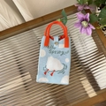 Detail of Hello Spring knitted bag featuring cloud pattern and orange round handles - Letter Swan - Phone Bag