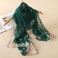 Elegant dark green chiffon scarf featuring white floral patterns on a wooden hanger - Dark Green White Plum