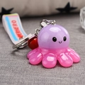 Detail of creative purple and pink octopus keychain with a LED light and superhero lanyard - Purple