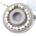White pearl bracelet with golden hollow beads and rhinestones on 13cm display - Flocked Plastic / Grey Sizing Tray (13cm)