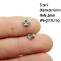 Macro shot of a 6mm star-shaped silver spacer bead on a fingertip for size scale - Size 9
