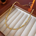 Dettaglio di una collana vintage bicolore intrecciata in un portagioie di legno - Collana Bicolore Oro e Argento