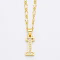 Detailed macro view of gold letter I pendant with micro-pave cubic zirconia on Figaro chain - Letter I