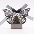 Macro shot of laser-cut silver butterfly gift box with elegant black chiffon ribbon - Mirror Grey