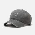 Macro detail of smiley face embroidery on a washed dark gray vintage baseball cap - Adjustable / Gray