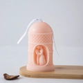 Pink pillar candle with geometric texture featuring an inner couple carving and ribbon - Kissing (Light Pink)