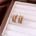 Detail of 18k gold plated vintage bow earrings with brown enamel and zircon inlay - 18K Gold Plated - Silver Pin / Gold Brown