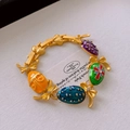 Detailed macro view of vintage bow and heart bracelet with colorful enamel egg charms - Vintage Enamel Egg Bow Bracelet