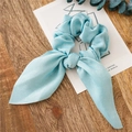 Light blue satin scrunchie with rabbit ear bow tie on a wooden background - Light Green