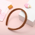 Single brown plush headband for women on soft pink background with cute props - Brown