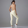 Detail of cross-back yoga bodysuit with scrunch butt lifting effect in cream white - S / Light Ivory