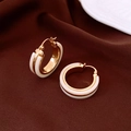 Detailed view of C-shaped gold-plated hoop earrings with white enamel on brown velvet - White C-Shape Ear Buckle (Genuine Gold Plated)