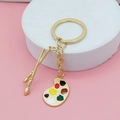 Llavero artístico dorado con paleta de colores vibrantes y colgantes de pinceles - Estilo de cadena de oro