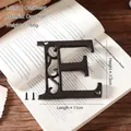 Industrial cast iron letter E wall decor with rustic bronze finish and mounting screws - Letter E
