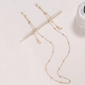 Gold beaded eyewear chain with wing pendants and adjustable non-slip rubber loops - Wing