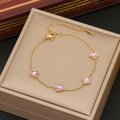 Elegant gold butterfly bracelet with purple crystals displayed on a beige jewelry box - Purple Butterfly Style / Gold
