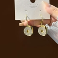 Detailed shot of sparkling pavé crystal hoop earrings with silver posts on display card - Gold Round Pave Rhinestone Earrings (E3683)