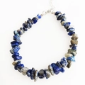Detailed macro view of irregular lapis lazuli and grey stone bracelet with adjustable clasp - Lapis Lazuli