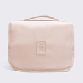 Light pink waterproof travel toiletry bag with handle and central travel logo tag - Beige