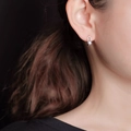 Silver geometric U-shaped earrings with white pearl detail shown on a model - Silver Plated Copper