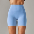 Detail view of high-waisted light blue yoga shorts showing seamless texture and wide waistband - Medium Blue & White