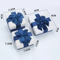 Three sizes of white jewelry gift boxes with elegant dark blue ribbon bows in a set - Navy and White