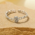 Adjustable silver chain ring with a diamond-encrusted infinity symbol on a stone surface - Silver-Letter S