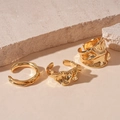 Macro view of gold-plated liquid metal lava rings on a minimalist stone background - Gold Wrinkle (Set of 3)
