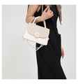 Detail of white crossbody bag with woven texture lid and golden circular buckle - White