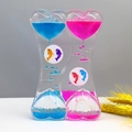 Detail of double heart liquid motion bubbler with pink and blue oil drops on gray desk - SY01 Heart Double Dolphins