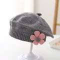 Detail of grey knitted beret featuring a soft pink flower and ribbed edge on stand - 3-48 Months / Gray