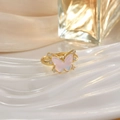 Elegant gold butterfly ring with pink gemstone and small diamonds on a white wavy surface - Pink Gemstone Rhinestone Butterfly Style (JZ0145A)
