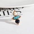 Vintage golden ring with three stacked natural stones on a white ceramic plate - White Pearl + Blue Sandstone